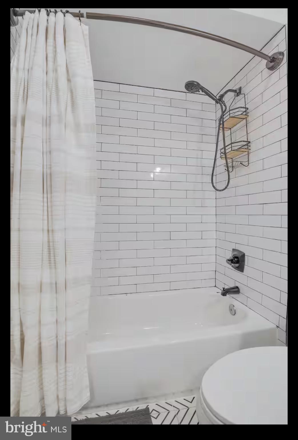 1255 Raum Street Northeast, Unit 1 Washington, DC 20002 - Photo 14 of 16 a bathroom with a shower and a bath tub
