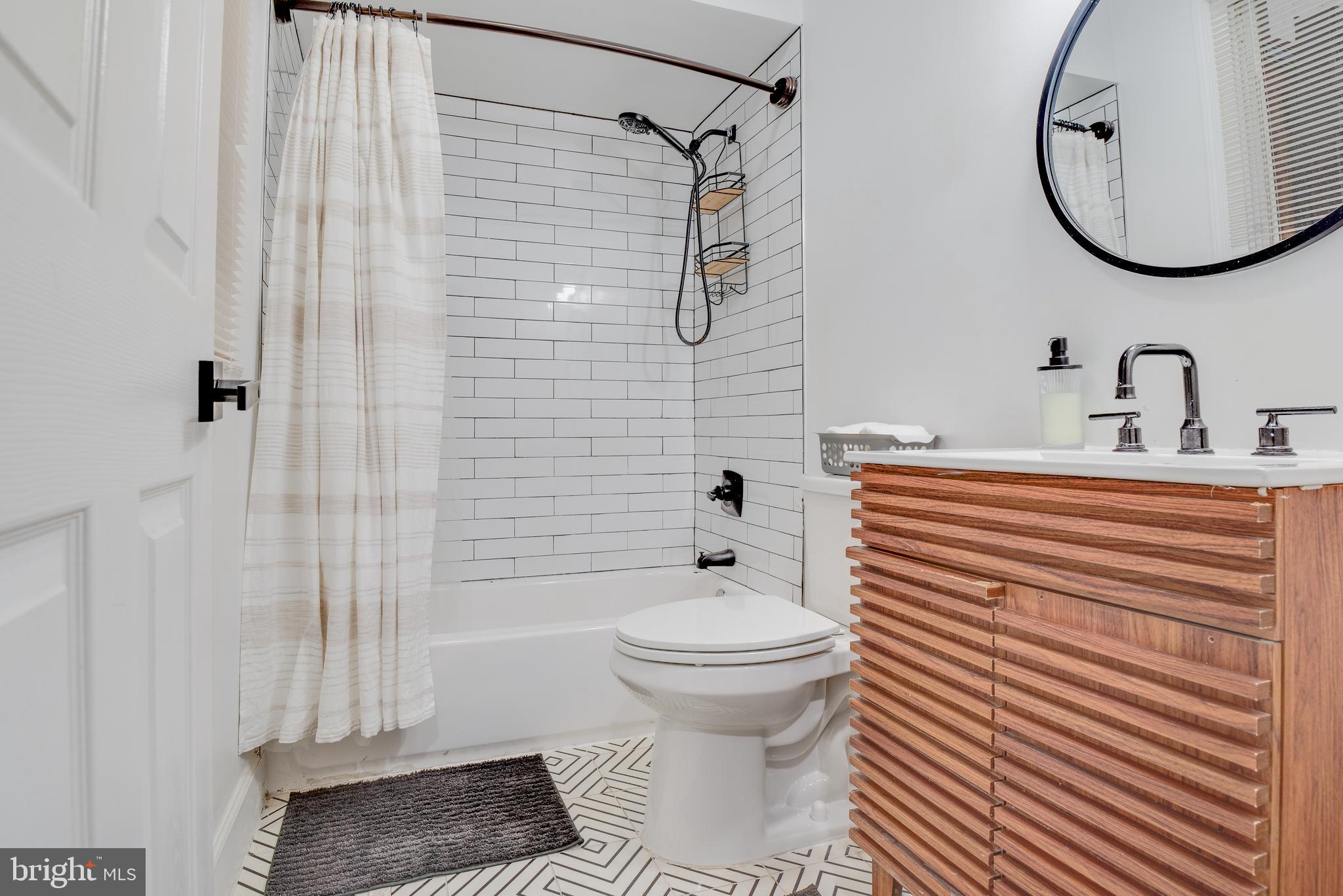 1255 Raum Street Northeast, Unit 1 Washington, DC 20002 - Photo 15 of 31 a bathroom with a sink toilet and shower