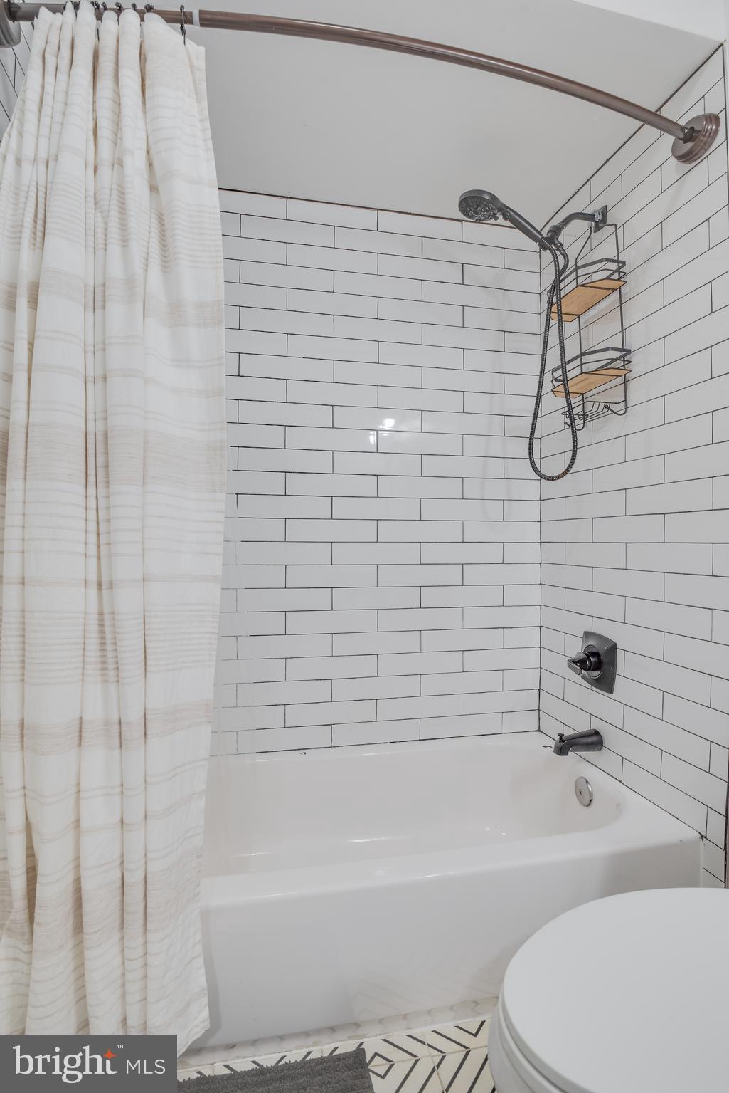 1255 Raum Street Northeast, Unit 1 Washington, DC 20002 - Photo 16 of 31 a bathroom with a toilet and a bath tub