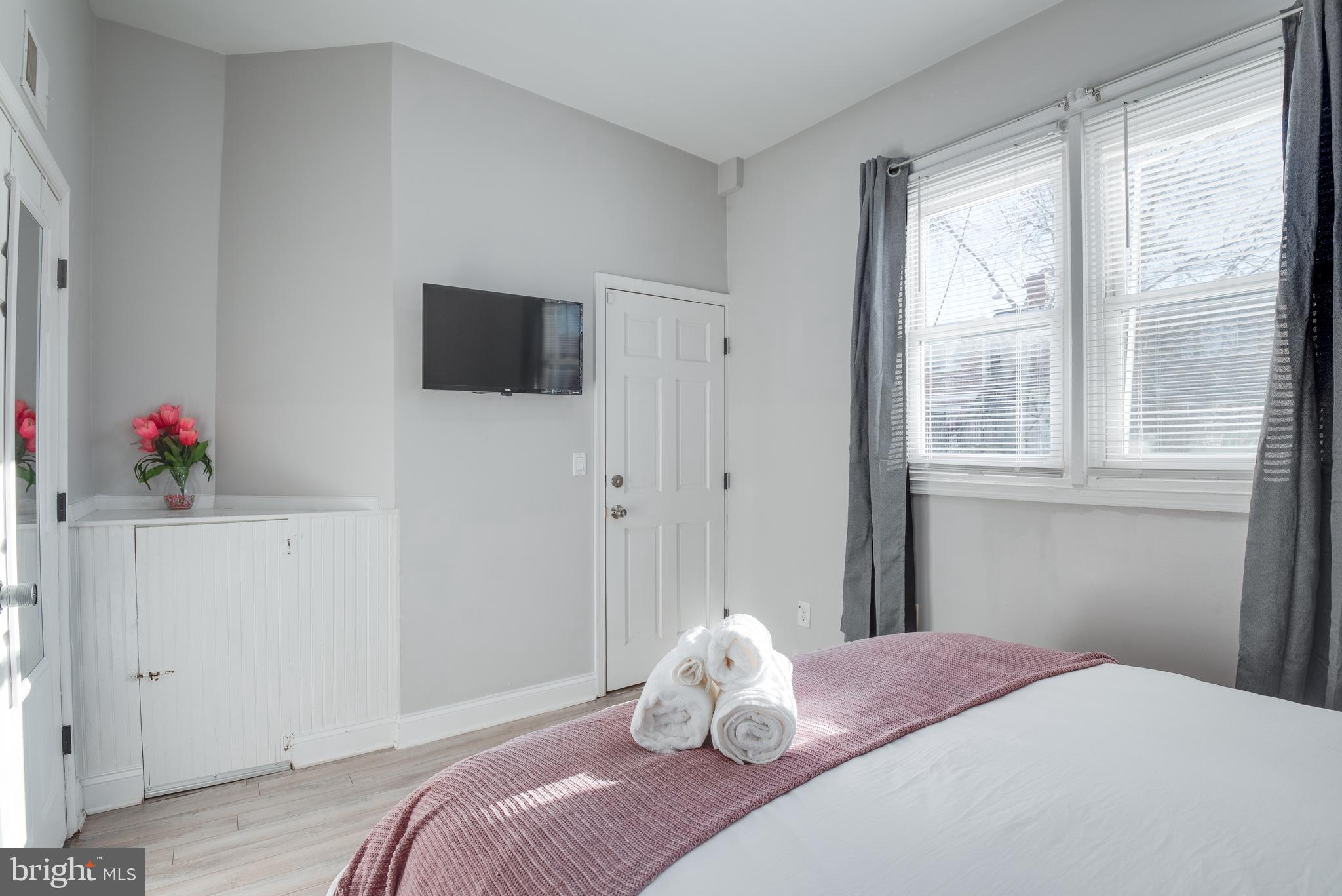1255 Raum Street Northeast, Unit 1 Washington, DC 20002 - Photo 22 of 31 a bedroom with a bed and a window