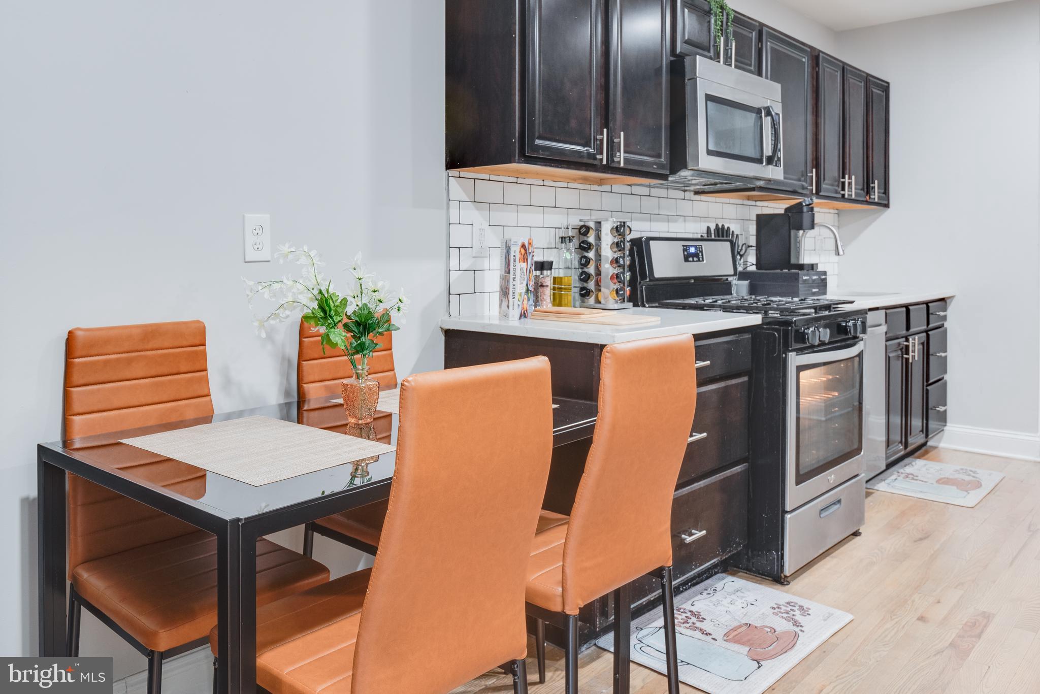 1255 Raum Street Northeast, Unit 1 Washington, DC 20002 - Photo 6 of 31 a kitchen with stainless steel appliances granite countertop a stove top oven a sink and dishwasher