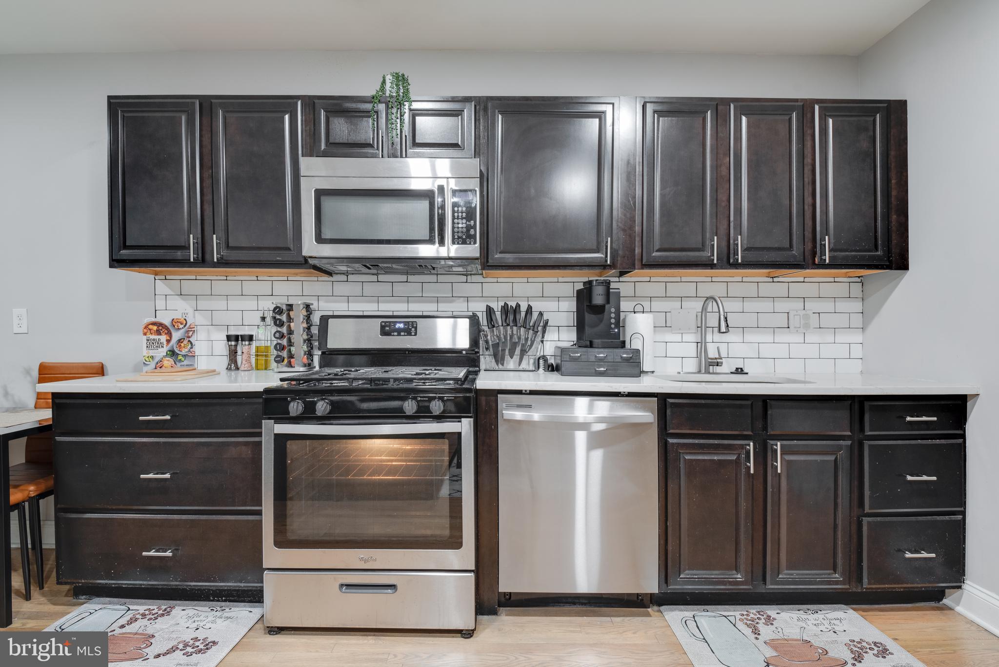1255 Raum Street Northeast, Unit 1 Washington, DC 20002 - Photo 10 of 31 a kitchen with stainless steel appliances granite countertop a stove a sink and a microwave