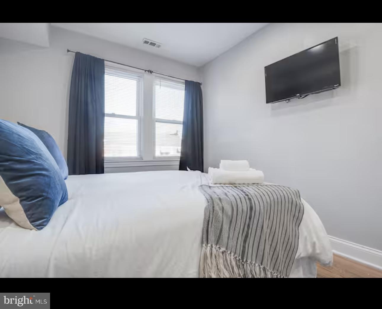1255 Raum Street Northeast, Unit 1 Washington, DC 20002 - Photo 10 of 16 a view of a bedroom with a flat screen tv