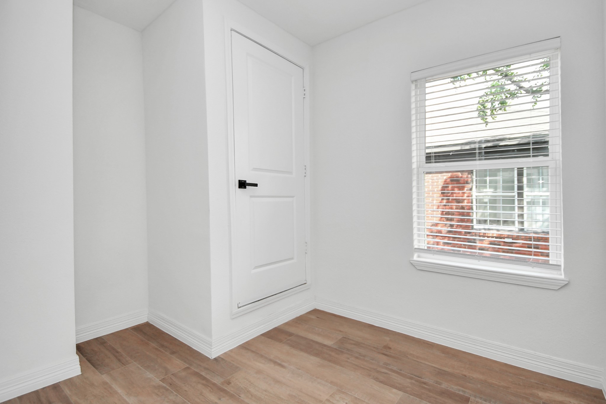 2812 Truxillo Street, Unit B Houston, TX 77004 - Photo 12 of 32 a view of an empty room with wooden floor and a window