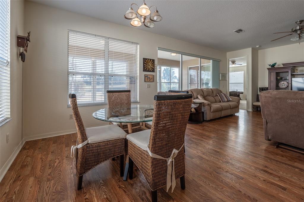 15803 Southwest 11th Court Road Ocala, FL 34473 - Photo 12 of 59 a view of a dining room with furniture window and wooden floor