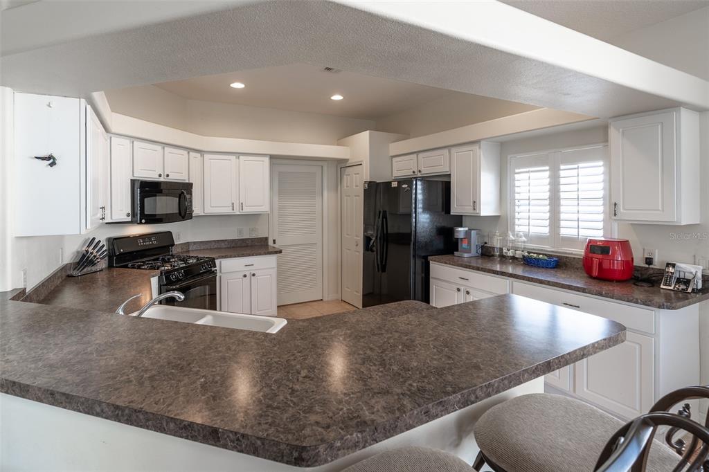 15803 Southwest 11th Court Road Ocala, FL 34473 - Photo 13 of 59 a kitchen with stainless steel appliances granite countertop a sink refrigerator and microwave