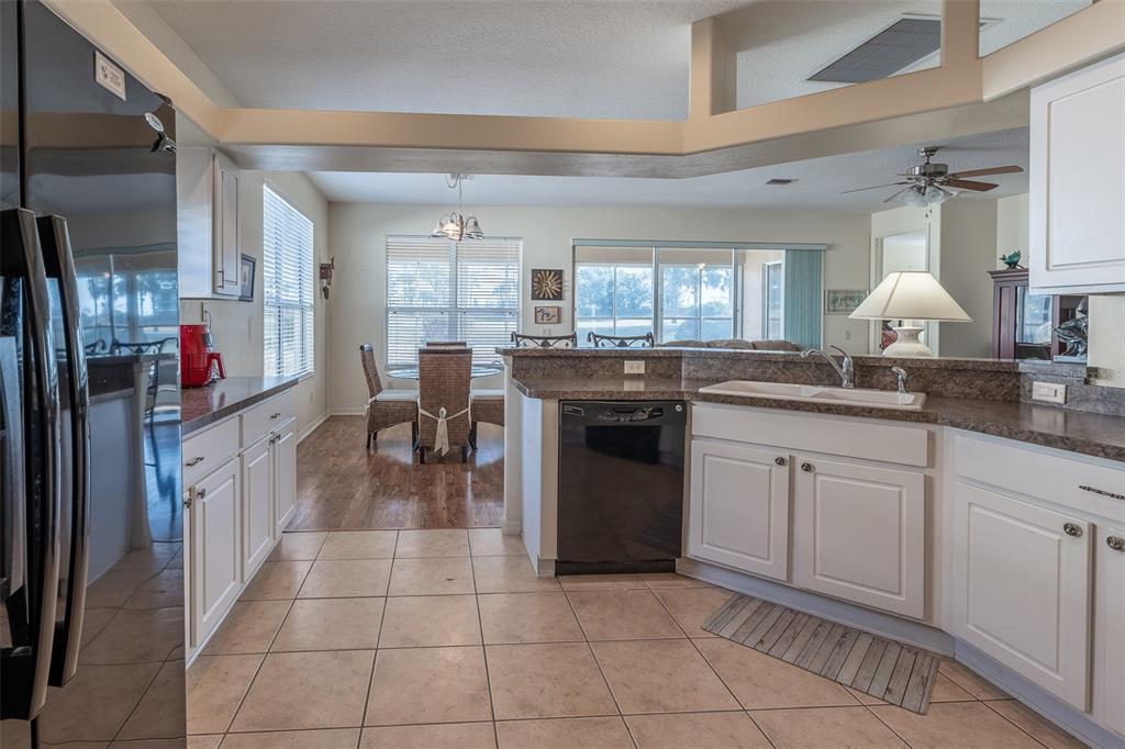 15803 Southwest 11th Court Road Ocala, FL 34473 - Photo 16 of 59 a kitchen with a sink counter top space appliances and cabinets