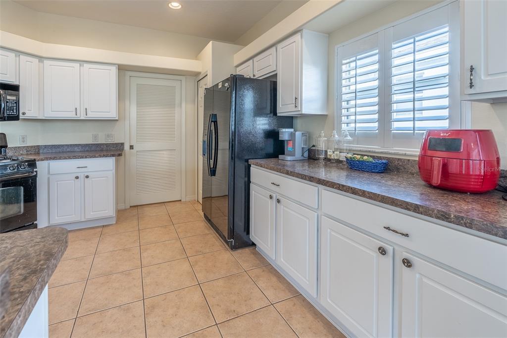 15803 Southwest 11th Court Road Ocala, FL 34473 - Photo 19 of 59 a kitchen with stainless steel appliances granite countertop a sink stove and refrigerator