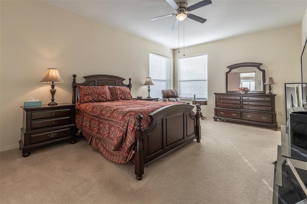 15803 Southwest 11th Court Road Ocala, FL 34473 - Photo 21 of 59 a bedroom with a bed and ceiling fan