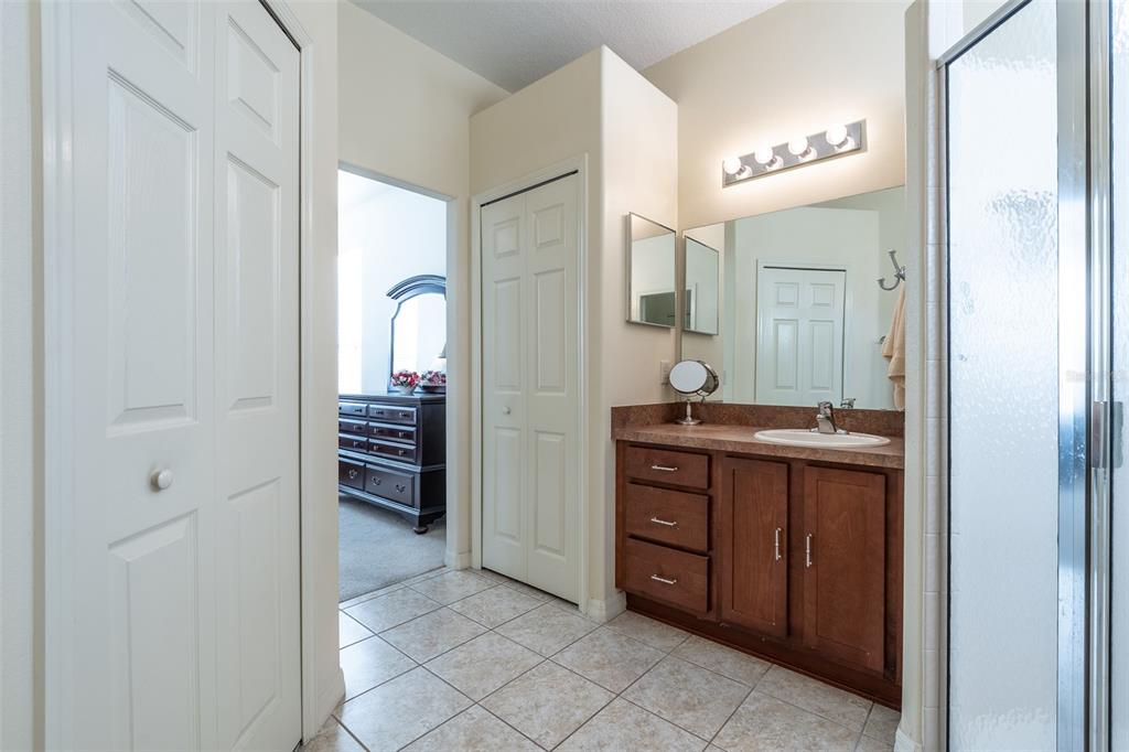 15803 Southwest 11th Court Road Ocala, FL 34473 - Photo 26 of 59 a spacious bathroom with a double vanity sink and a mirror