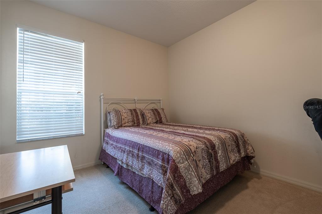 15803 Southwest 11th Court Road Ocala, FL 34473 - Photo 29 of 59 a bedroom with a bed window and a night stand