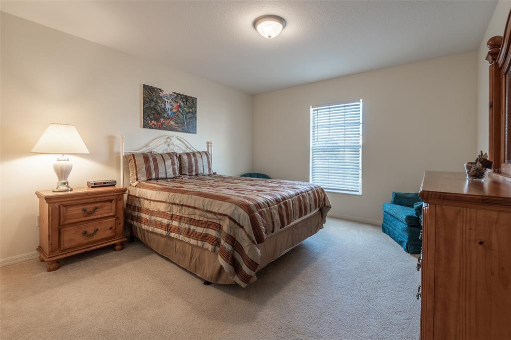 15803 Southwest 11th Court Road Ocala, FL 34473 - Photo 32 of 59 a bedroom with a bed and a tv on the dresser