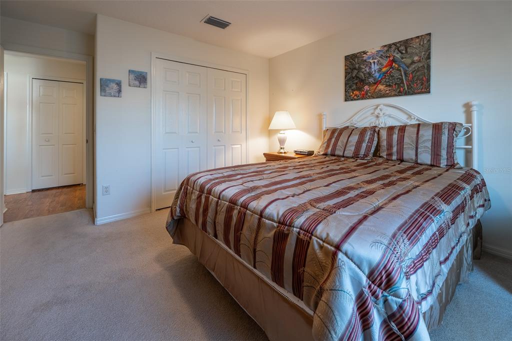 15803 Southwest 11th Court Road Ocala, FL 34473 - Photo 33 of 59 a bedroom with a bed and lamp