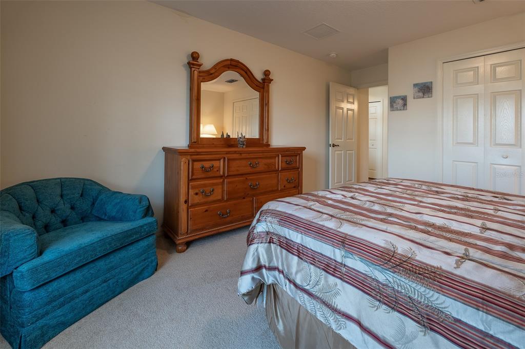 15803 Southwest 11th Court Road Ocala, FL 34473 - Photo 34 of 59 a bedroom with a bed and a dresser