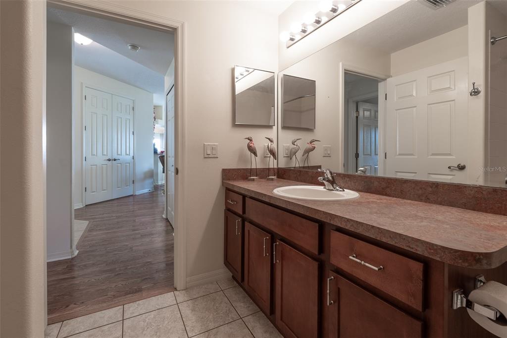 15803 Southwest 11th Court Road Ocala, FL 34473 - Photo 36 of 59 a bathroom with a granite countertop sink and a mirror