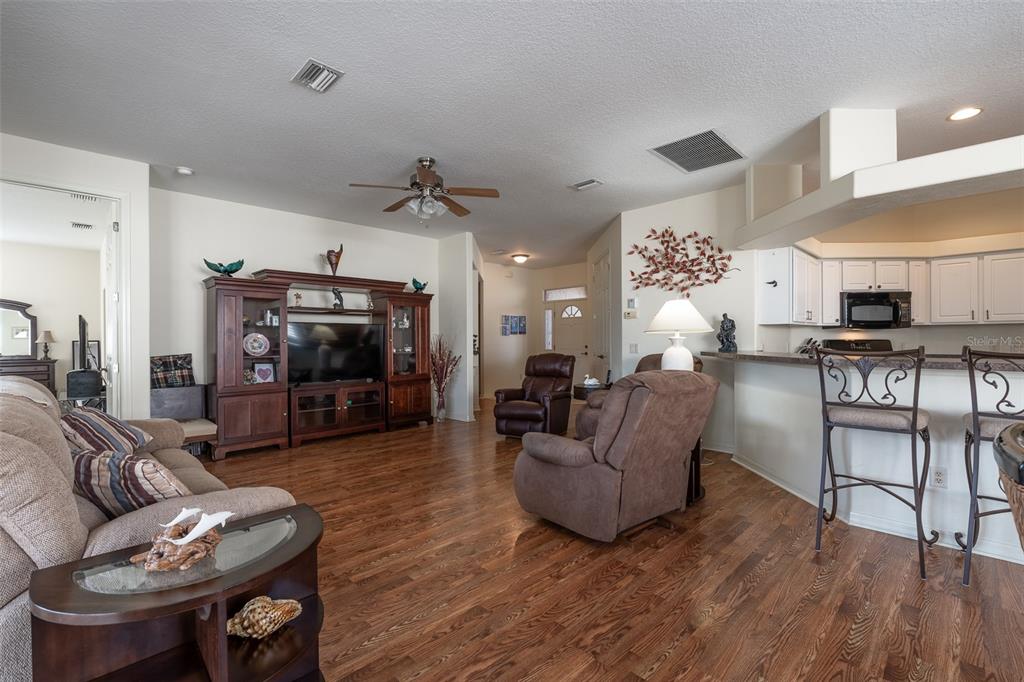15803 Southwest 11th Court Road Ocala, FL 34473 - Photo 8 of 59 a living room with furniture and a wooden floor