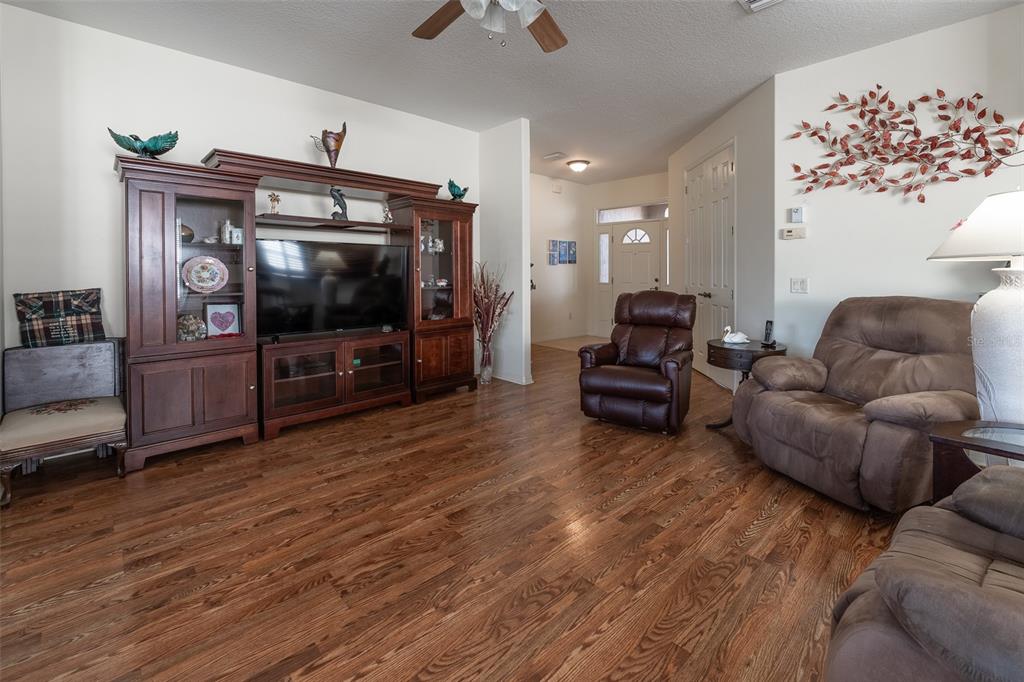 15803 Southwest 11th Court Road Ocala, FL 34473 - Photo 9 of 59 a living room with furniture and a flat screen tv