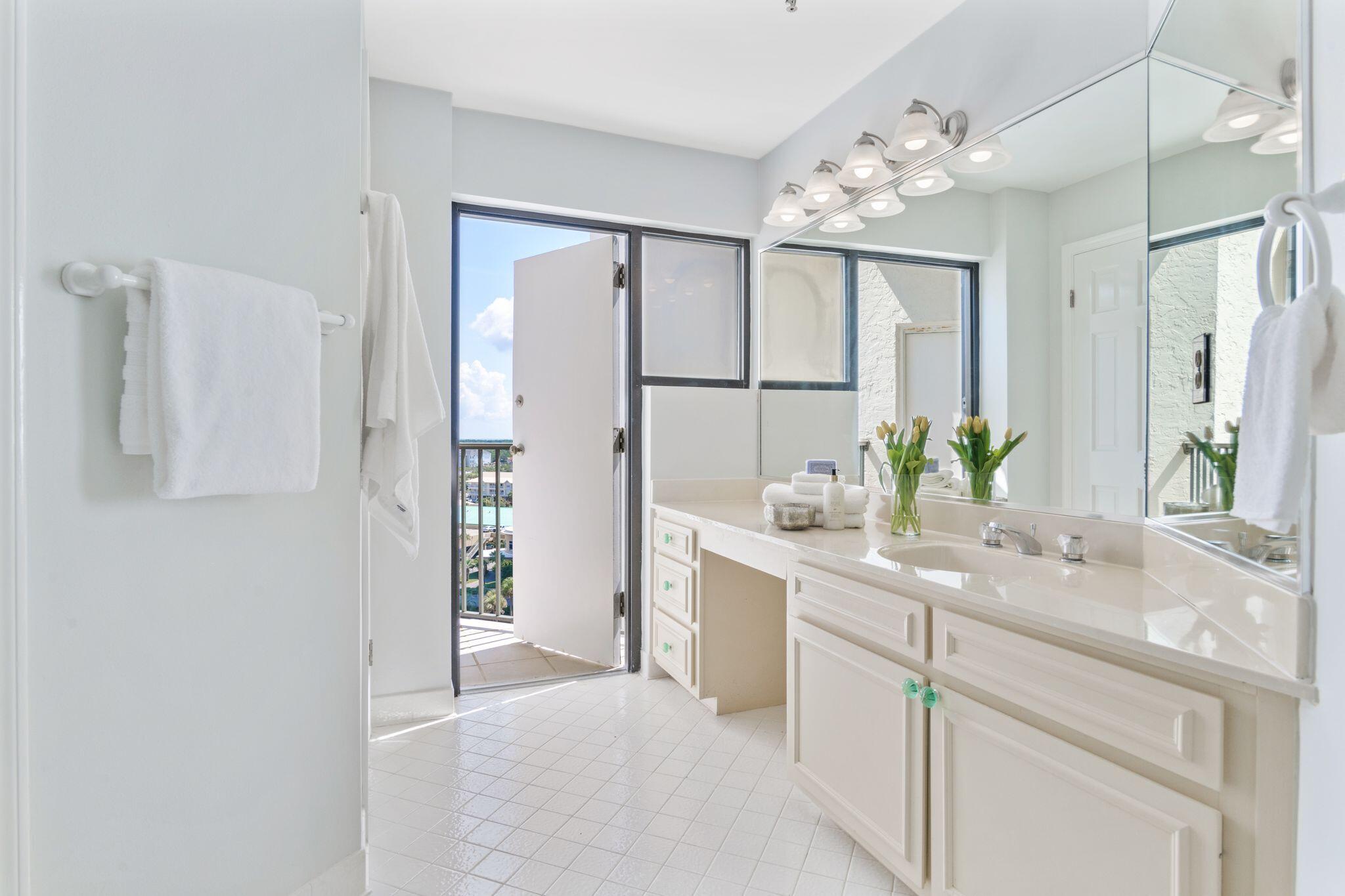 950 Highway 98, Unit 7101 Destin, FL 32541 - Photo 18 of 74 a bathroom with a double vanity sink mirror and shower