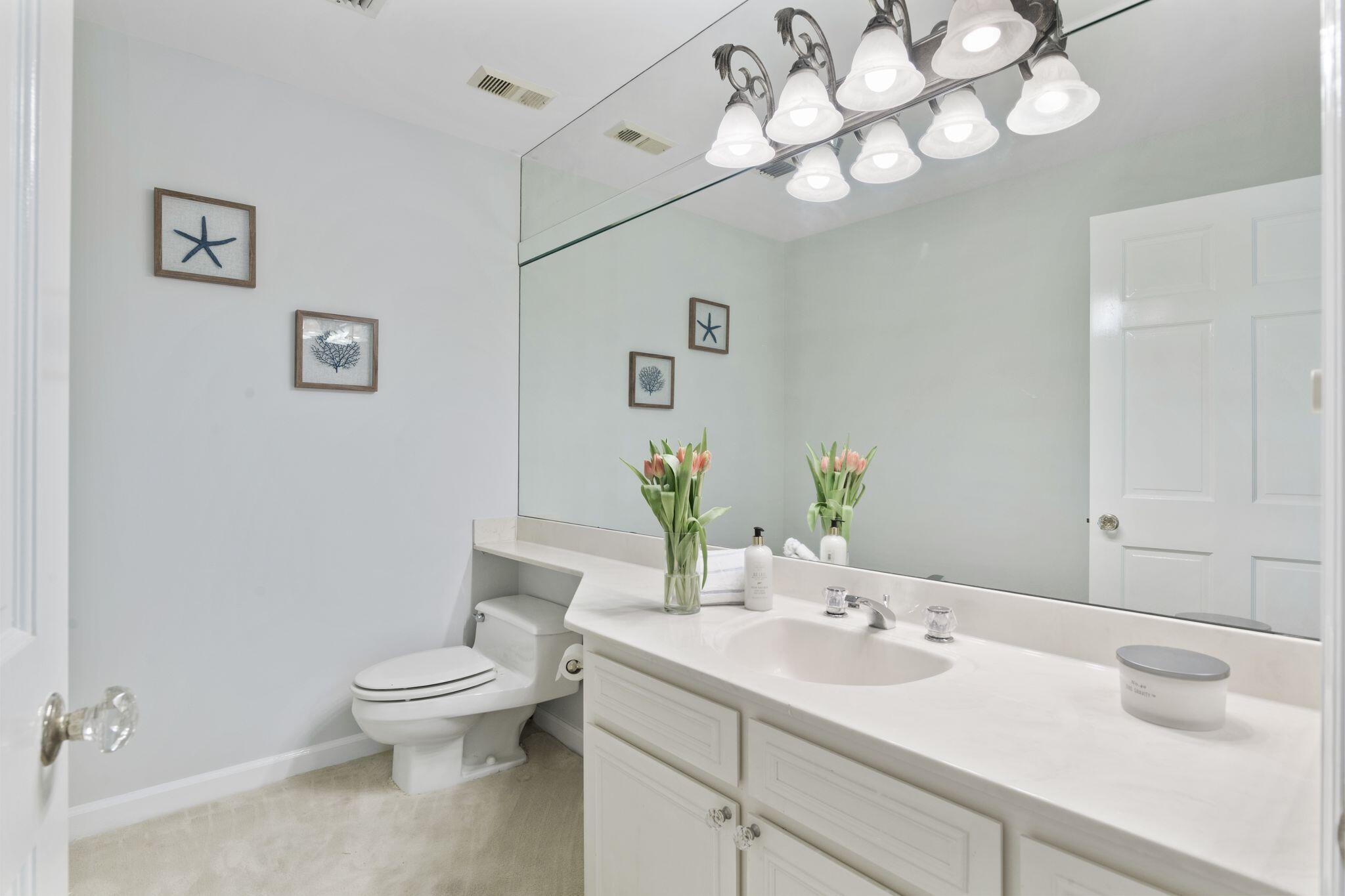 950 Highway 98, Unit 7101 Destin, FL 32541 - Photo 23 of 74 a bathroom with a toilet sink and mirror