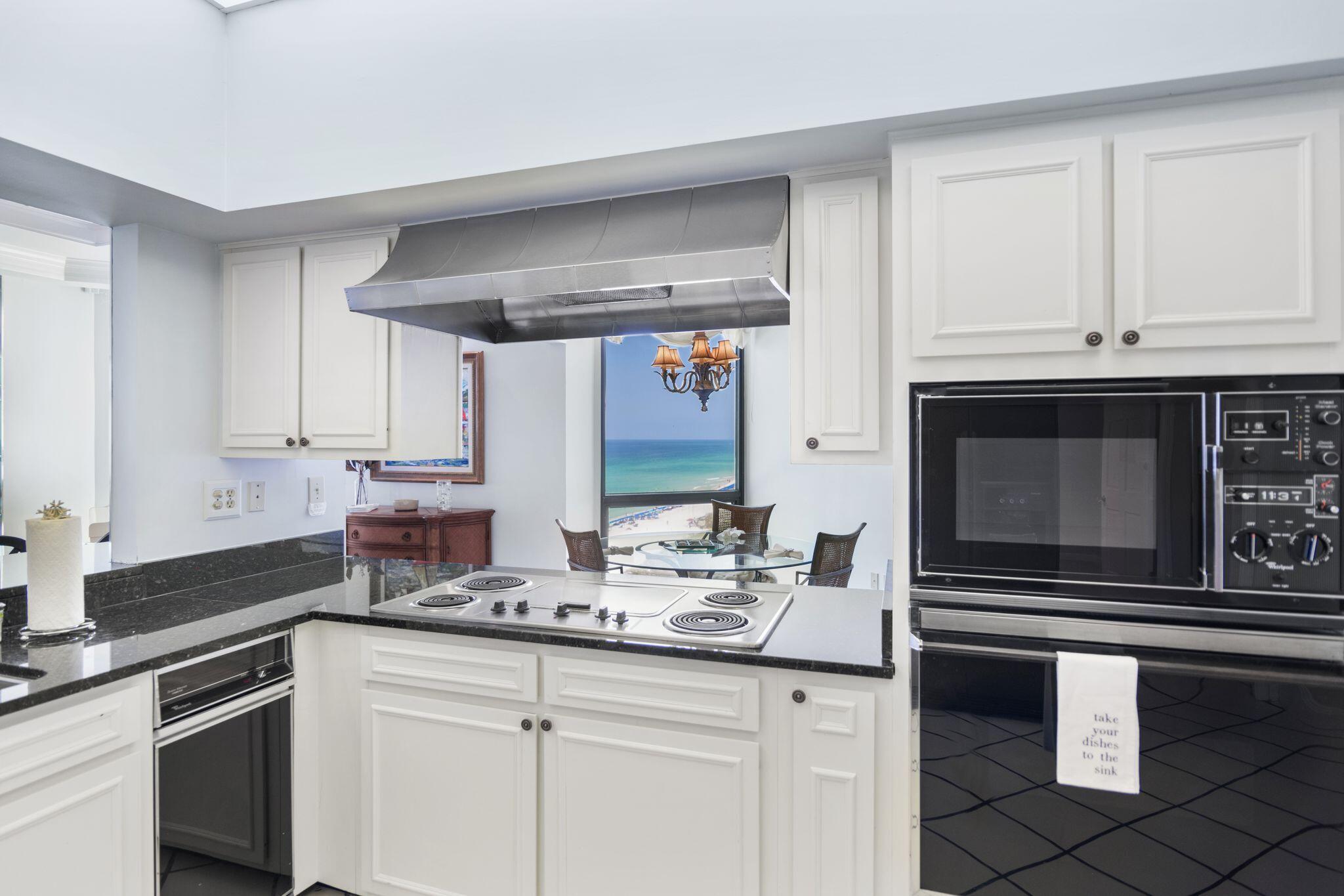 950 Highway 98, Unit 7101 Destin, FL 32541 - Photo 26 of 74 a kitchen with stainless steel appliances white cabinets and a sink