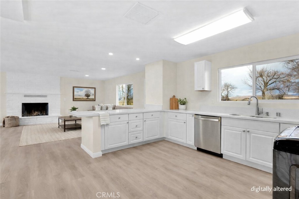 47424 Paddington Landers, CA 92285 - Photo 12 of 67 a kitchen with granite countertop white cabinets and white appliances