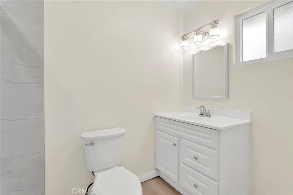 47424 Paddington Landers, CA 92285 - Photo 21 of 67 a bathroom with a toilet a sink a vanity and mirror