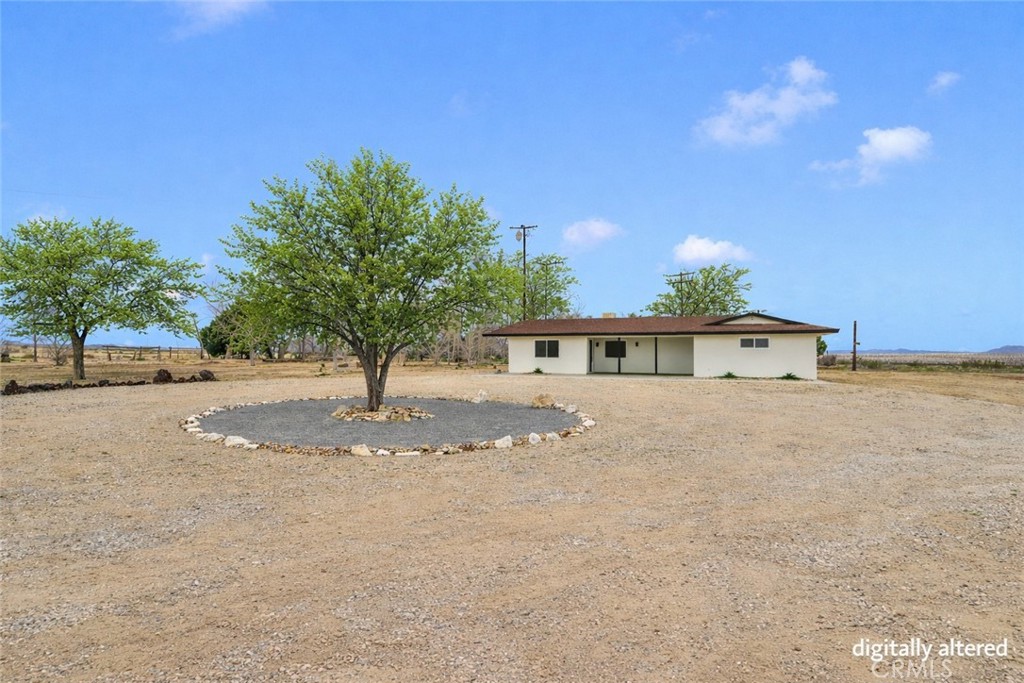 47424 Paddington Landers, CA 92285 - Photo 3 of 67 a front view of a house with a yard and garage