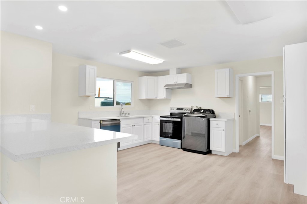 47424 Paddington Landers, CA 92285 - Photo 56 of 67 a kitchen with stainless steel appliances kitchen island granite countertop a refrigerator and a sink