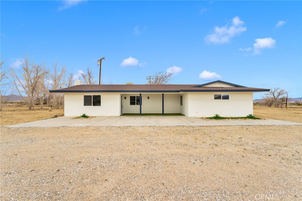 47424 Paddington Landers, CA 92285 - Photo 57 of 67 a front view of a house with a yard and garage