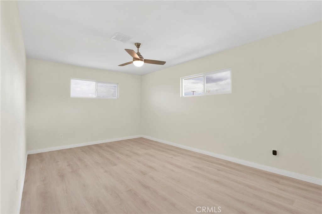47424 Paddington Landers, CA 92285 - Photo 65 of 67 an empty room with a window and a ceiling fan