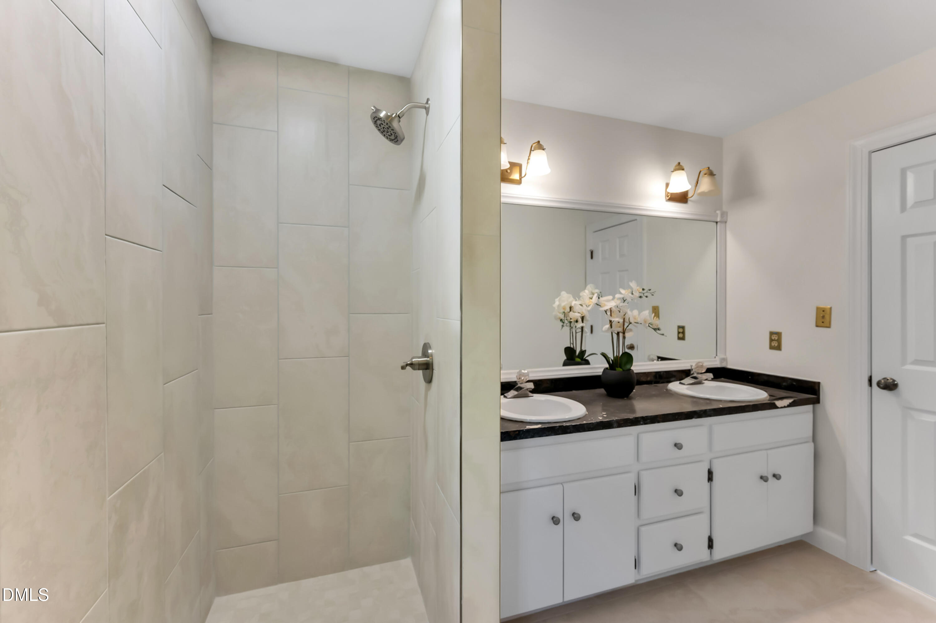 7500 Drayton Court Raleigh, NC 27615 - Photo 13 of 27 a bathroom with a granite countertop sink a mirror and a shower