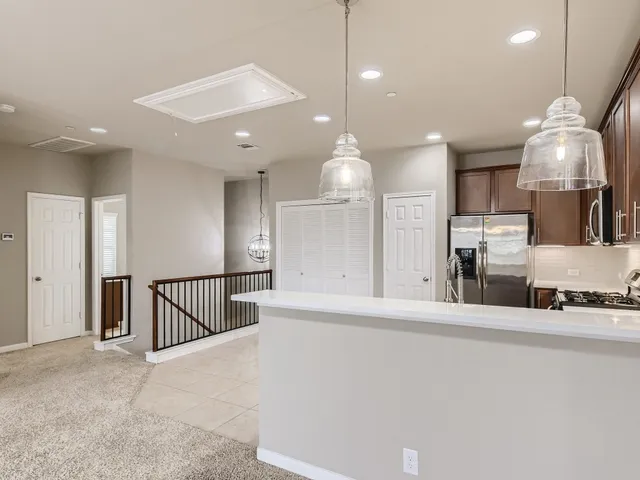 a view of a kitchen with a sink and a chandelier