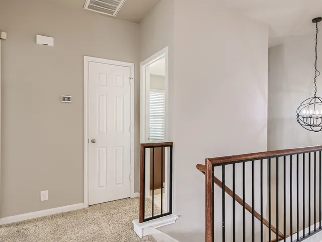 a view of a hallway with window and stairs