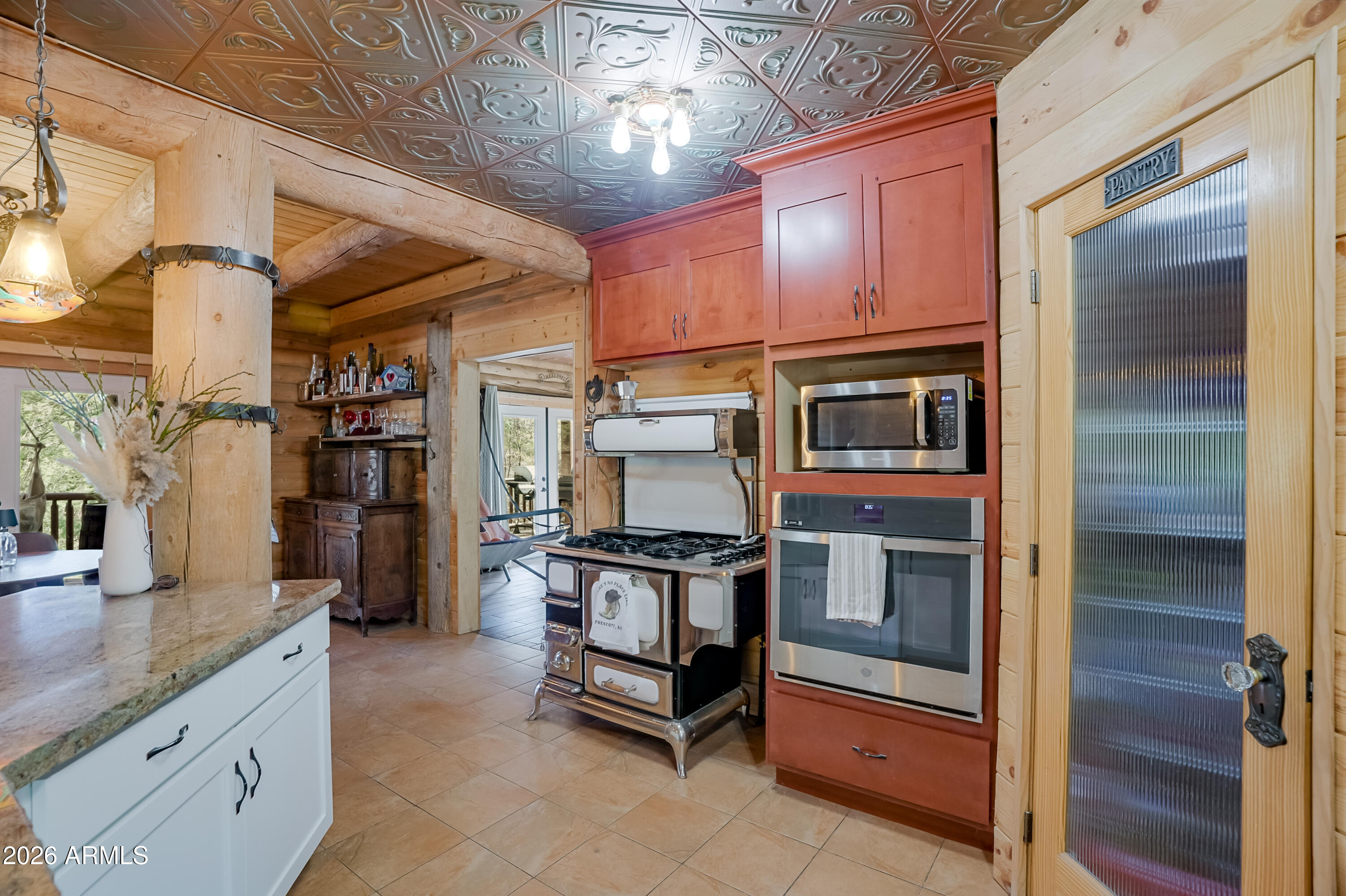 8105 South Comstock Mine Road Prescott, AZ 86303 - Photo 13 of 62 a kitchen with stainless steel appliances granite countertop a stove and a refrigerator