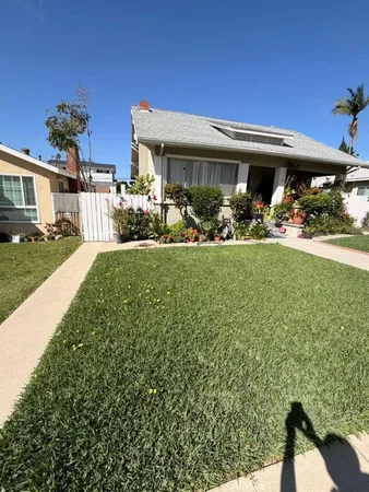 a view of a house with backyard sitting area and garden