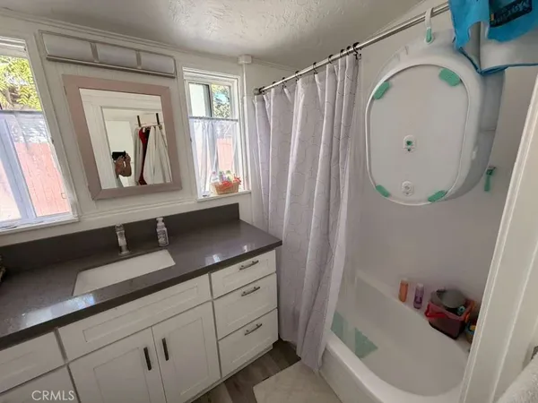 a bathroom with a sink a mirror and a bathtub