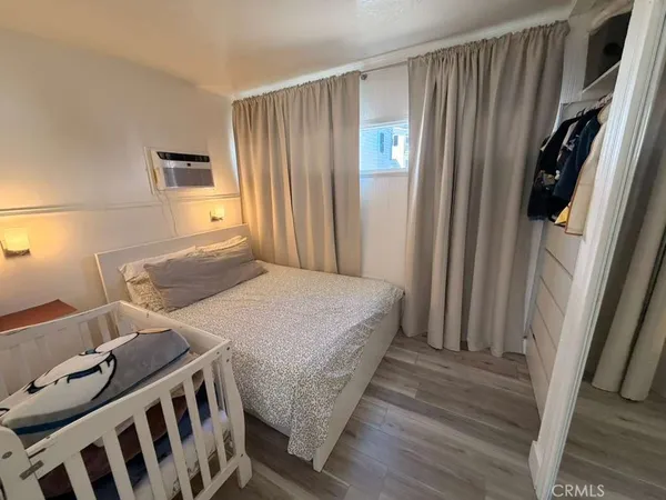 a bedroom with a bed and a mirror