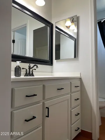 a bathroom with a sink vanity and mirror
