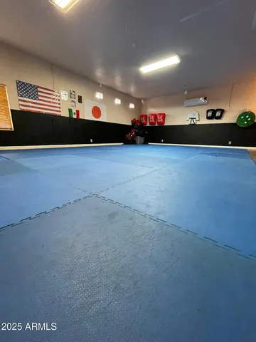 a view of an empty room with kitchen view