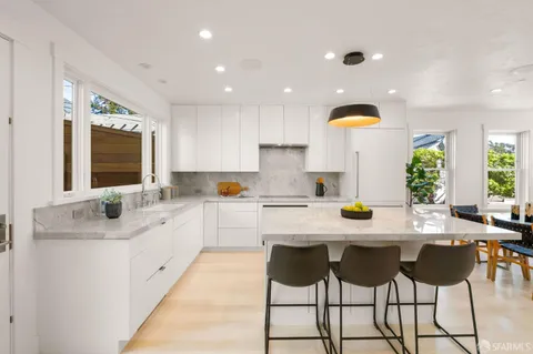 a kitchen with a sink cabinets and window