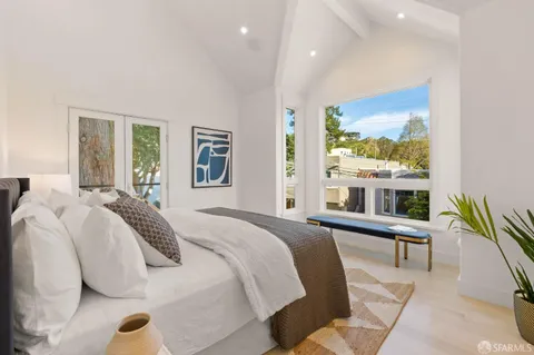 a bedroom with a large bed and a large window