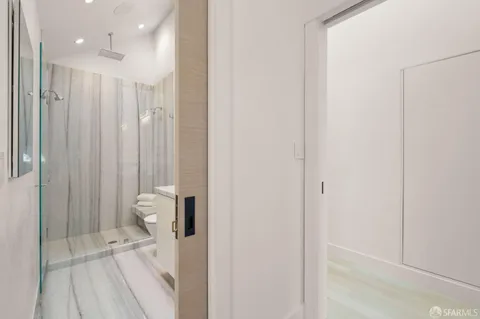 a view of a bathroom with a shower and a sink
