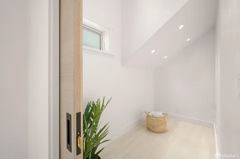 a bedroom with a bed and large windows