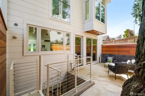 a balcony with furniture and wooden floor
