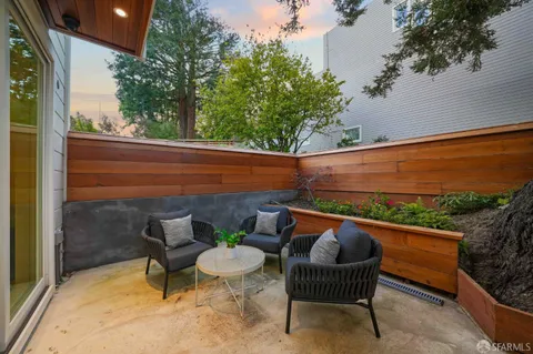 a balcony with furniture and wooden floor