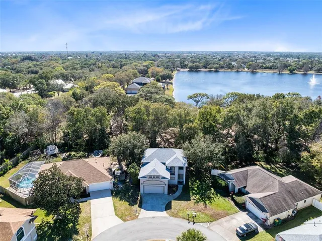 an aerial view of a house with a lake view