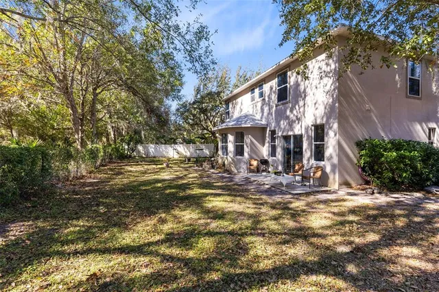 a view of a house with backyard and sitting area