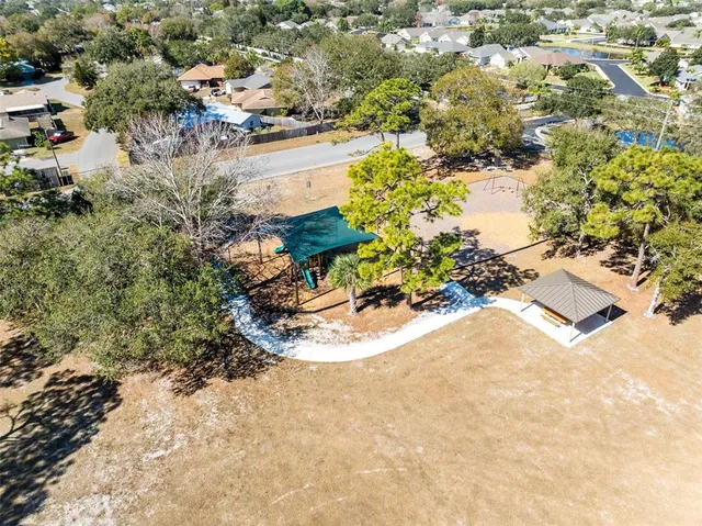 an aerial view of a house with a yard and sitting area