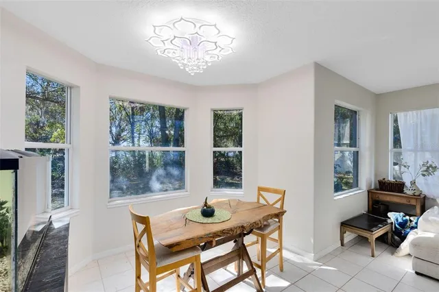 a view of a dining room with furniture and chandelier