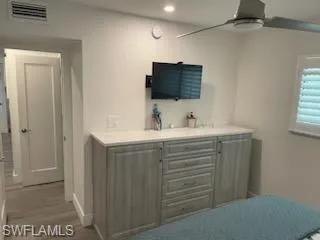 a bathroom with a sink vanity and mirror